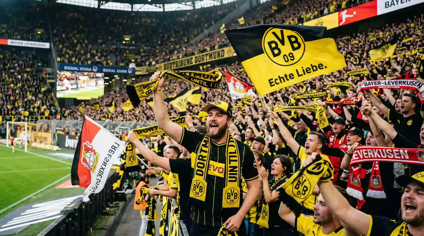 Aficionados socios de un club de la Bundesliga mostrando bufandas y banderas en la grada del estadio
